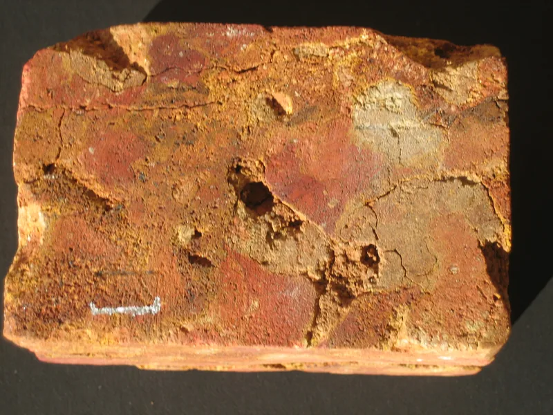 Laterite cut into building blocks — the same soil that makes hard work for the plough makes easy work for the mason.